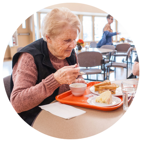 Woman enjoying soup and sandwich lunch in the Golden Circle Dining Room.